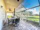 Screened lanai with patio furniture and views of the yard and golf course at 13252 Norman Cir, Hudson, FL 34669