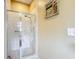 Modern shower with glass door and neutral wall art at 13252 Norman Cir, Hudson, FL 34669