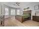 Spacious main bedroom featuring wood-look floors and a large window providing natural light at 13831 Rudi Loop, Spring Hill, FL 34609