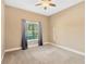 Bedroom with large window, gray curtains and carpeted flooring at 13911 Artesa Bell Dr, Riverview, FL 33579