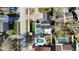 Birds eye view of the house, with solar panels on the roof and a screened-in pool in the backyard at 15701 Springmoss Ln, Tampa, FL 33624