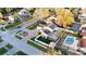 Aerial view of a home with solar panels, swimming pool, and lush landscaping at 15701 Springmoss Ln, Tampa, FL 33624