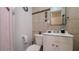 Bathroom featuring new vanity, decorative wall hangings, and tiled walls at 15701 Springmoss Ln, Tampa, FL 33624