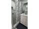 Bright bathroom featuring a white vanity, framed mirror, and tile shower, designed for comfort and style at 15701 Springmoss Ln, Tampa, FL 33624