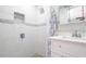 Bright bathroom featuring a tiled shower with niche and a modern vanity at 15701 Springmoss Ln, Tampa, FL 33624