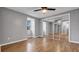 Bright bedroom with mirrored closets, wood flooring, and a window overlooking the exterior at 15701 Springmoss Ln, Tampa, FL 33624