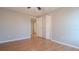 Cozy bedroom featuring wood floors, double door closet, and neutral paint, ready for personalization at 15701 Springmoss Ln, Tampa, FL 33624