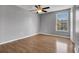 The bedroom features wood floors, neutral paint, one window, and a ceiling fan at 15701 Springmoss Ln, Tampa, FL 33624