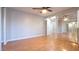 Spacious bedroom with wood flooring, mirrored closet doors, and ample natural light at 15701 Springmoss Ln, Tampa, FL 33624