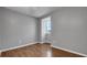 This bedroom features wood floors and one small window at 15701 Springmoss Ln, Tampa, FL 33624