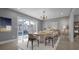 Elegant dining room with large windows overlooking the pool and a stylish dining set at 15701 Springmoss Ln, Tampa, FL 33624