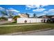 Exterior view of home featuring a white privacy fence and well-manicured lawn at 15701 Springmoss Ln, Tampa, FL 33624
