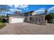 View of this home highlighting the attached garage, brick driveway, and solar panels for eco-friendly living at 15701 Springmoss Ln, Tampa, FL 33624