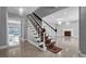 Grand foyer featuring elegant staircase and marble flooring bathed in natural light at 15701 Springmoss Ln, Tampa, FL 33624