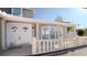 Elegant home entrance showcasing double doors, decorative columns, and a tiled front porch at 15701 Springmoss Ln, Tampa, FL 33624