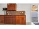Efficient kitchen with ample wooden cabinets, granite countertops, and a modern microwave at 15701 Springmoss Ln, Tampa, FL 33624