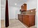 Efficient kitchen with ample wooden cabinets, granite countertops, and a modern refrigerator at 15701 Springmoss Ln, Tampa, FL 33624