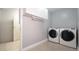 Functional laundry area featuring modern washer and dryer units, enhancing the home's convenience at 15701 Springmoss Ln, Tampa, FL 33624