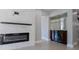 Close up of the contemporary electric fireplace and adjacent bar area at 15701 Springmoss Ln, Tampa, FL 33624