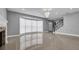 Bright living room with large windows and natural light showcases the elegant staircase at 15701 Springmoss Ln, Tampa, FL 33624