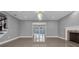 Spacious living room with tile flooring, fireplace, and seamless indoor/outdoor flow at 15701 Springmoss Ln, Tampa, FL 33624