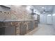 Outdoor kitchen with stainless steel cabinets, a stone backsplash, and ample counter space at 15701 Springmoss Ln, Tampa, FL 33624
