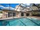 An expansive screened-in pool area provides a refreshing oasis alongside the home's outdoor living space at 15701 Springmoss Ln, Tampa, FL 33624