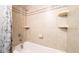 Tiled shower with decorative mosaic stripe and built in shelves showcasing a modern bathroom design at 15701 Springmoss Ln, Tampa, FL 33624