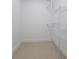 Spacious walk-in closet with white wire shelving and neutral flooring provides ample storage at 15701 Springmoss Ln, Tampa, FL 33624