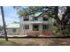 View of new two-story home under construction with porch columns and black window frames, and landscaping at 515 Bosphorous Ave, Tampa, FL 33606