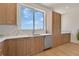 Contemporary kitchen with stainless steel appliances, quartz countertops, and stylish wood cabinetry at 1 Aqua Reserve Blvd, New Port Richey, FL 34652