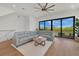 Spacious living room with comfortable seating, a ceiling fan, and sliding glass doors with outdoor views at 1 Aqua Reserve Blvd, New Port Richey, FL 34652