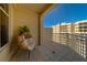 Relaxing balcony features a comfortable wicker chair with cushion, offering a cozy outdoor space at 10 Papaya St # 1404, Clearwater Beach, FL 33767