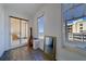 View of balcony with sliding glass door and gray wood floors, plus windows showing city and ocean views at 10 Papaya St # 1404, Clearwater Beach, FL 33767