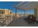 Expansive balcony with a pergola, offering shaded seating and beautiful city and water views at 10 Papaya St # 1404, Clearwater Beach, FL 33767