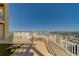 Spacious tiled balcony with white railings, dining table, and stunning panoramic views of the city and bay at 10 Papaya St # 1404, Clearwater Beach, FL 33767