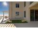 Wide angle of a large balcony that offers outdoor dining and games with access to gulf views at 10 Papaya St # 1404, Clearwater Beach, FL 33767