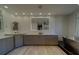 Modern bathroom featuring double vanities, a large mirror, and tiled floors with a soaking tub at 10 Papaya St # 1404, Clearwater Beach, FL 33767
