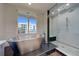 Bright bathroom features tiled walls, a soaking tub, and glass-enclosed shower, plus an outside view at 10 Papaya St # 1404, Clearwater Beach, FL 33767