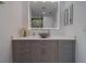 Bathroom boasts a modern vanity with a vessel sink and a large illuminated mirror at 10 Papaya St # 1404, Clearwater Beach, FL 33767