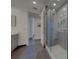 Modern bathroom featuring a glass-enclosed shower with gray tiling and a gray vanity at 10 Papaya St # 1404, Clearwater Beach, FL 33767