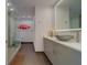 Modern bathroom featuring a glass shower, contemporary vanity, and decorative artwork at 10 Papaya St # 1404, Clearwater Beach, FL 33767