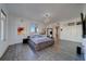 Bright bedroom features gray wood floors, a modern chandelier, and ocean views from multiple windows at 10 Papaya St # 1404, Clearwater Beach, FL 33767