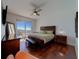 Relaxing bedroom with a king-sized bed, ceiling fan and access to a private balcony with water views at 10 Papaya St # 1404, Clearwater Beach, FL 33767