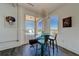 Bright dining area with modern glass table and industrial accents, next to balcony access at 10 Papaya St # 1404, Clearwater Beach, FL 33767