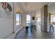 Bright dining area with a modern glass table, industrial accents, and a balcony at 10 Papaya St # 1404, Clearwater Beach, FL 33767