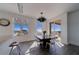 Dining area with modern chandelier, large windows offering beautiful views, and access to a terrace at 10 Papaya St # 1404, Clearwater Beach, FL 33767