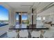 Dining area with an modern light fixture and balcony at 10 Papaya St # 1404, Clearwater Beach, FL 33767