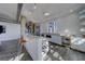 Modern kitchen features a breakfast bar, wine storage, stainless steel appliances, and stylish white cabinetry at 10 Papaya St # 1404, Clearwater Beach, FL 33767