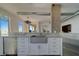 Modern kitchen features stainless appliances, white cabinets, and a farmhouse sink with a view at 10 Papaya St # 1404, Clearwater Beach, FL 33767